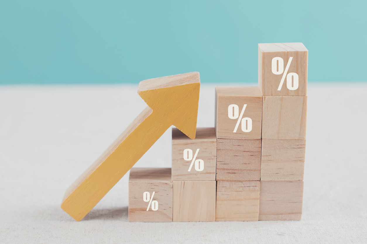 Wooden blocks with percentage sign and arrow up, financial growth, interest rate increase, inflation concept