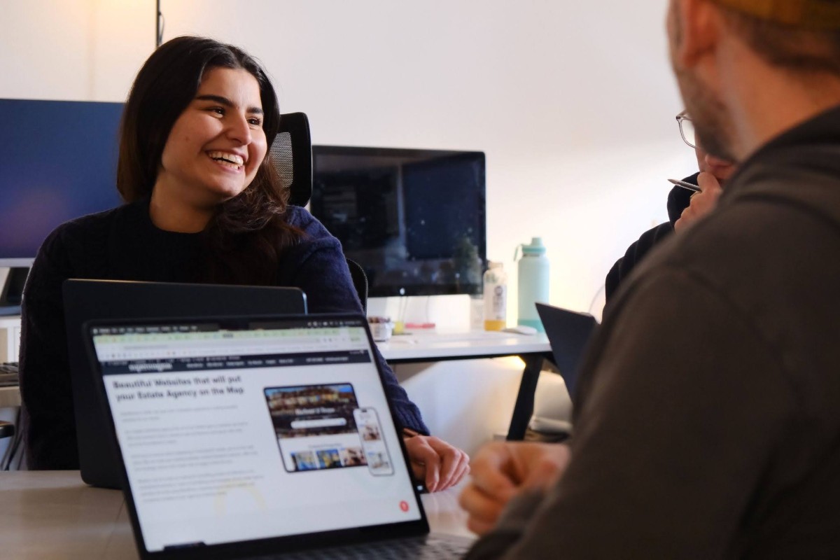 The 2026 Guide to Estate Agent Websites 5 A happy smiling with other colleagues in the office